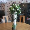 wedding venue breakfast table centrepiece very tall vase floral arrangement