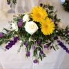 wedding venue flowers top table trailing long floral display purple yellow 