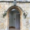 Notley Abbey wedding venue front door arch flower garland spray on either s
