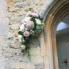Notley Abbey wedding venue front door arch flower garland spray blush ivory