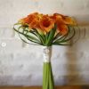 Missenden Abbey Brides bouquet of orange calla lilies with Grandmothers bro